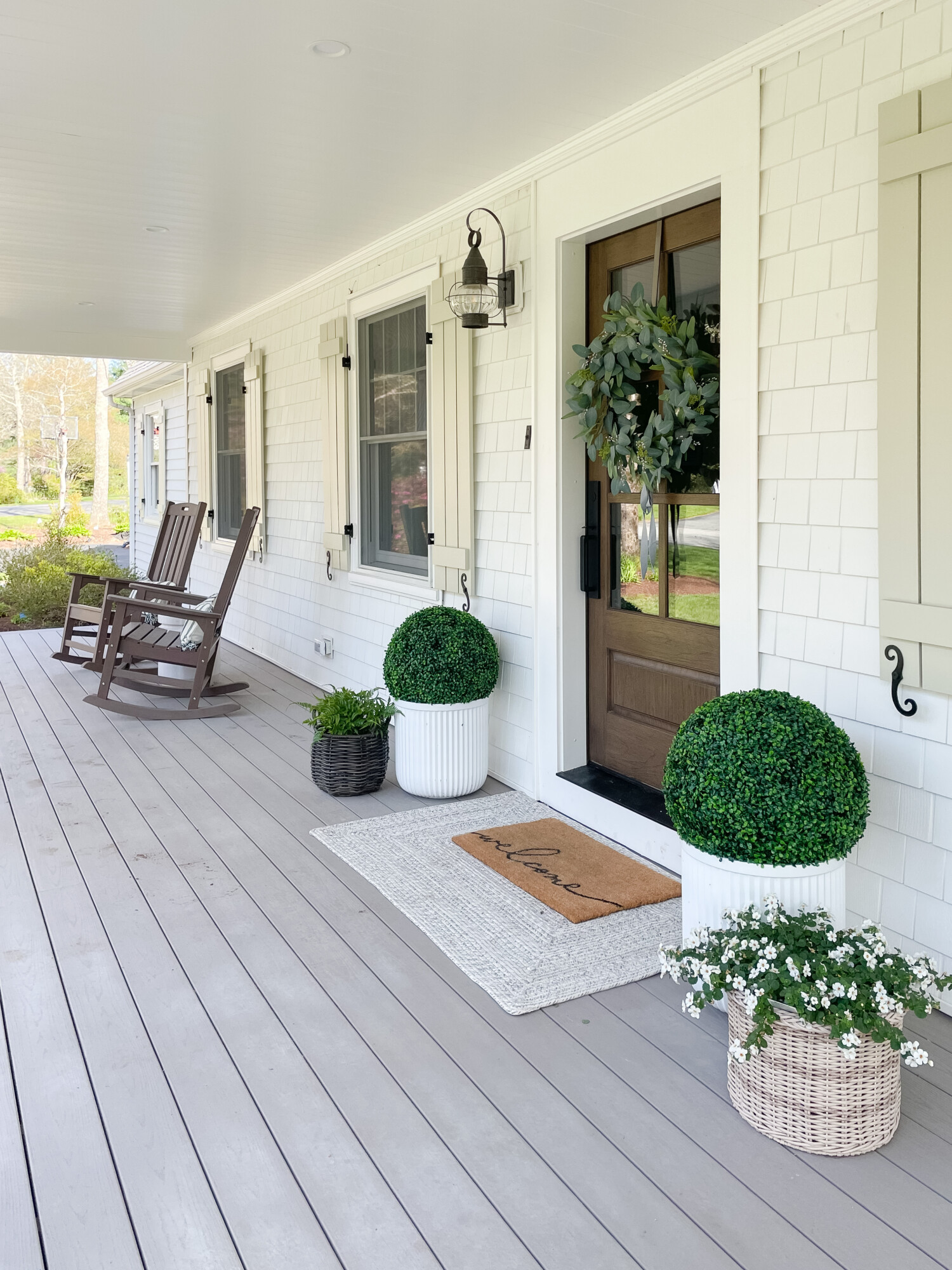 spring front porch styling | spring, spring front porch, spring home, home decor, front porch, rocking chairs, faux greenery, planters, wreath, lighting, welcome mat