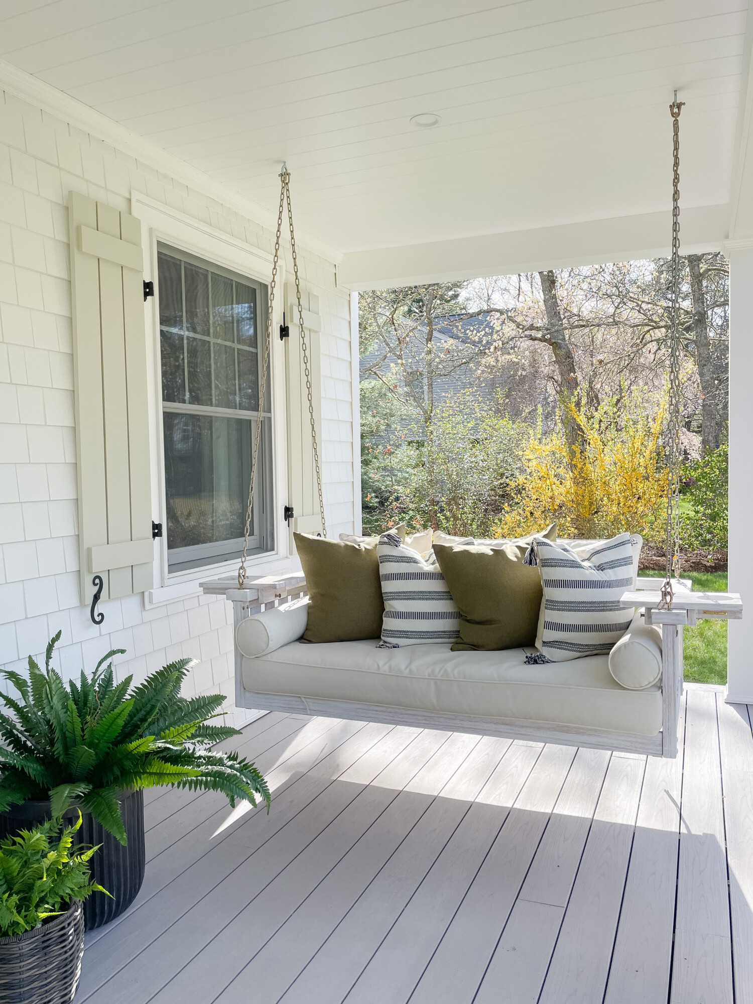 spring front porch styling | spring, spring front porch, spring home, home decor, front porch, outdoor seating, porch swing, swinging bench, throw pillows, coastal home, faux greenery, boston fern