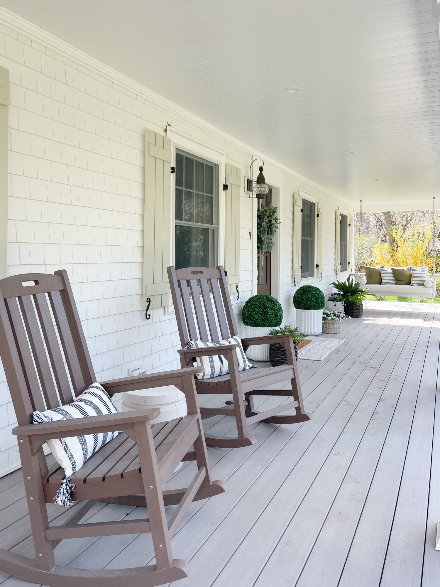 spring front porch styling | spring, spring front porch, spring home, home decor, front porch, outdoor seating, rocking chairs, planters, faux greenery, porch swing, wreath