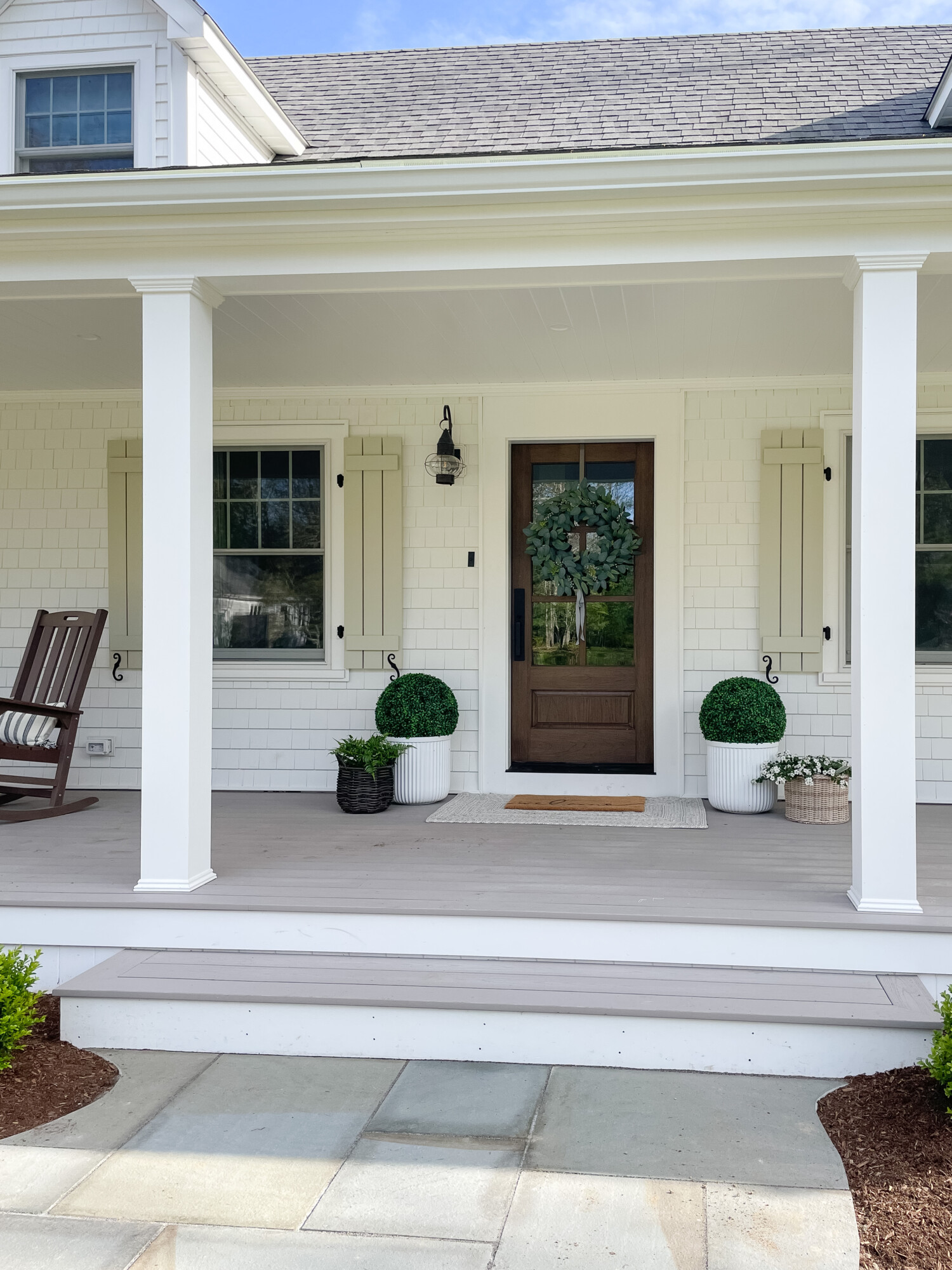 spring front porch styling | spring, spring front porch, spring home, home decor, front porch, wreath, hanging wreath, planters, faux greenery, decor, basket, flowers, walkway, blue stone