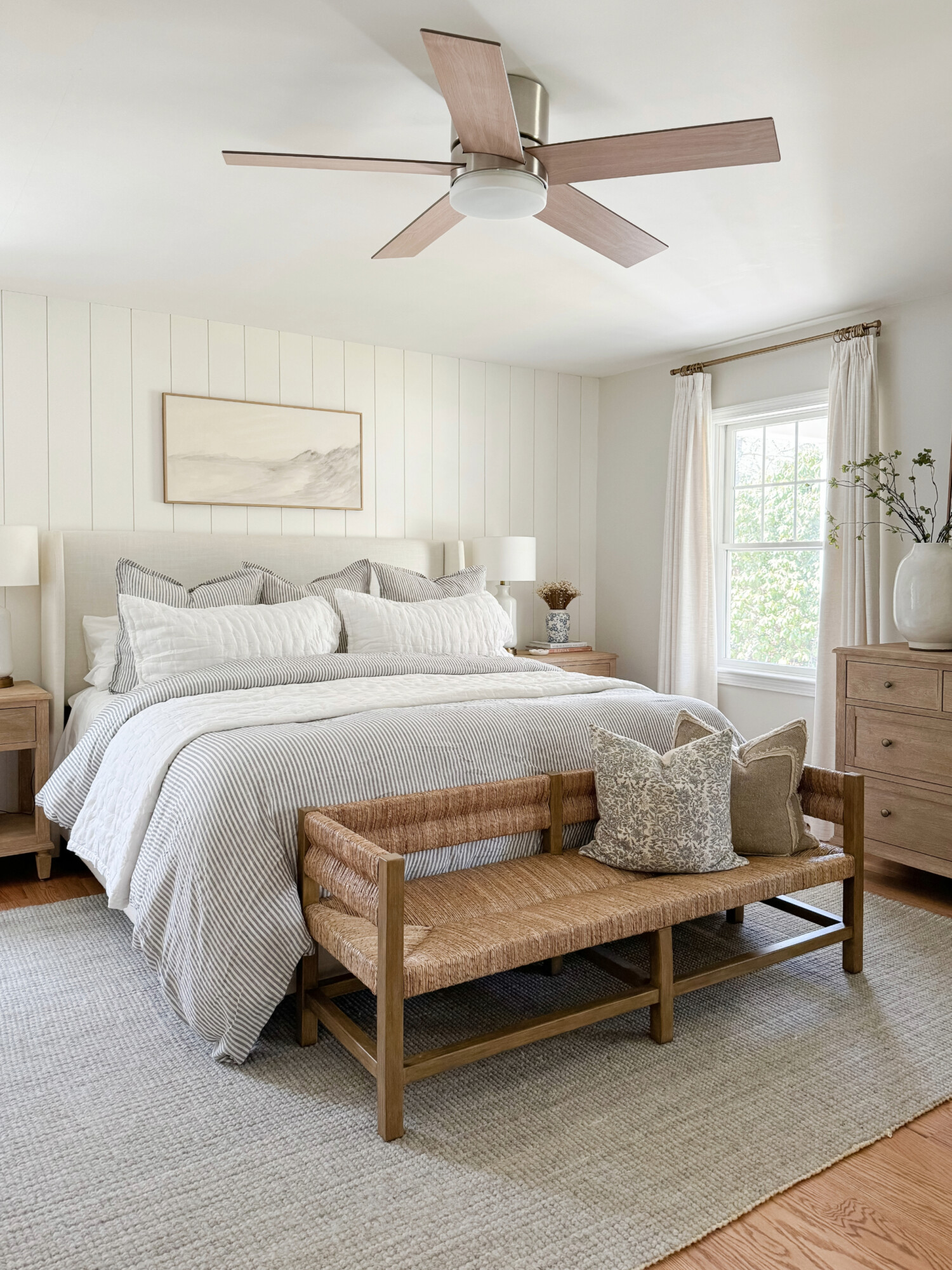 coastal beige master bedroom with quince bedding, neutral bed from wayfair, and pottery barn wood furniture