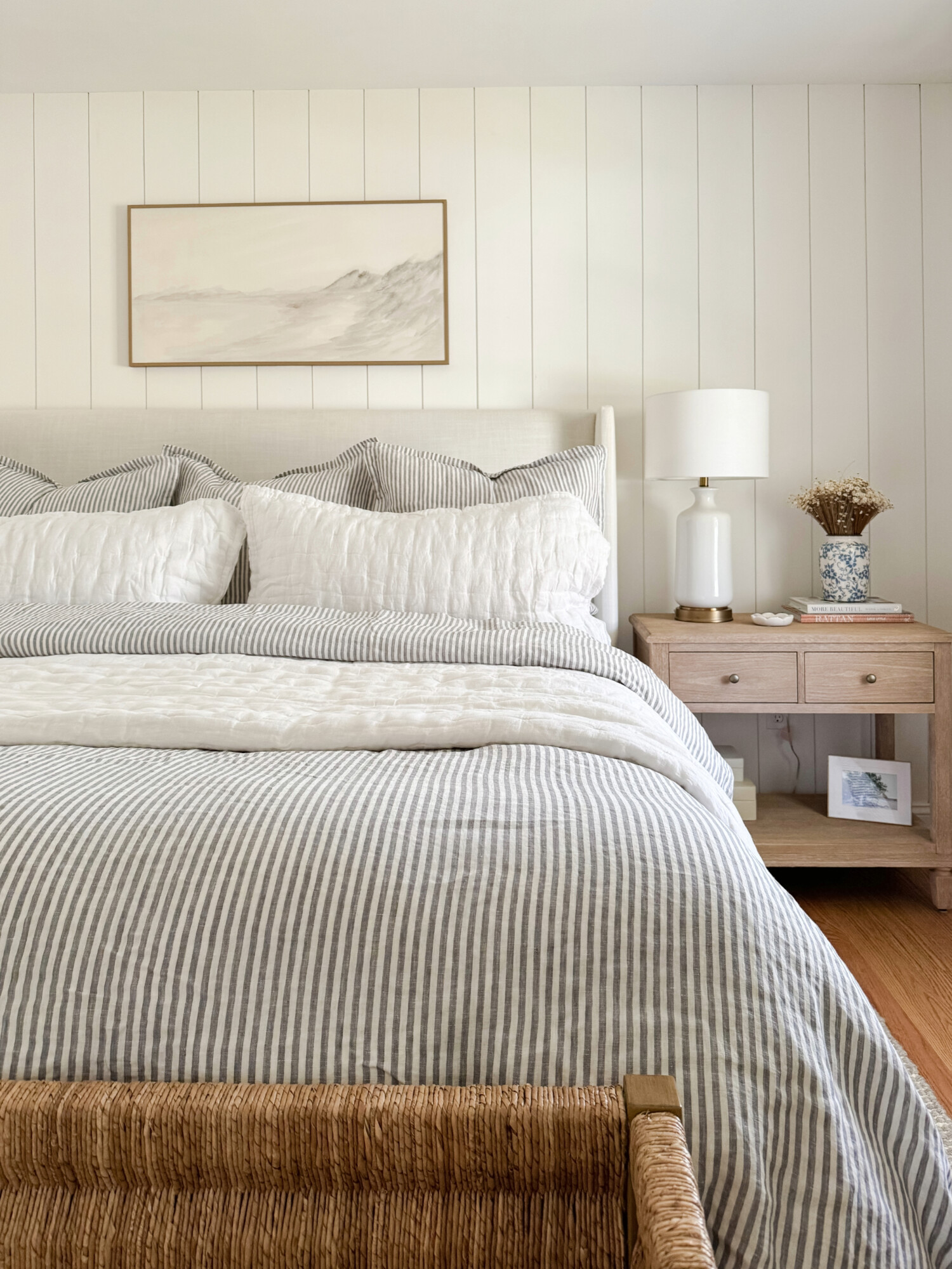 beige bed from wayfair and striped and white bedding from quince