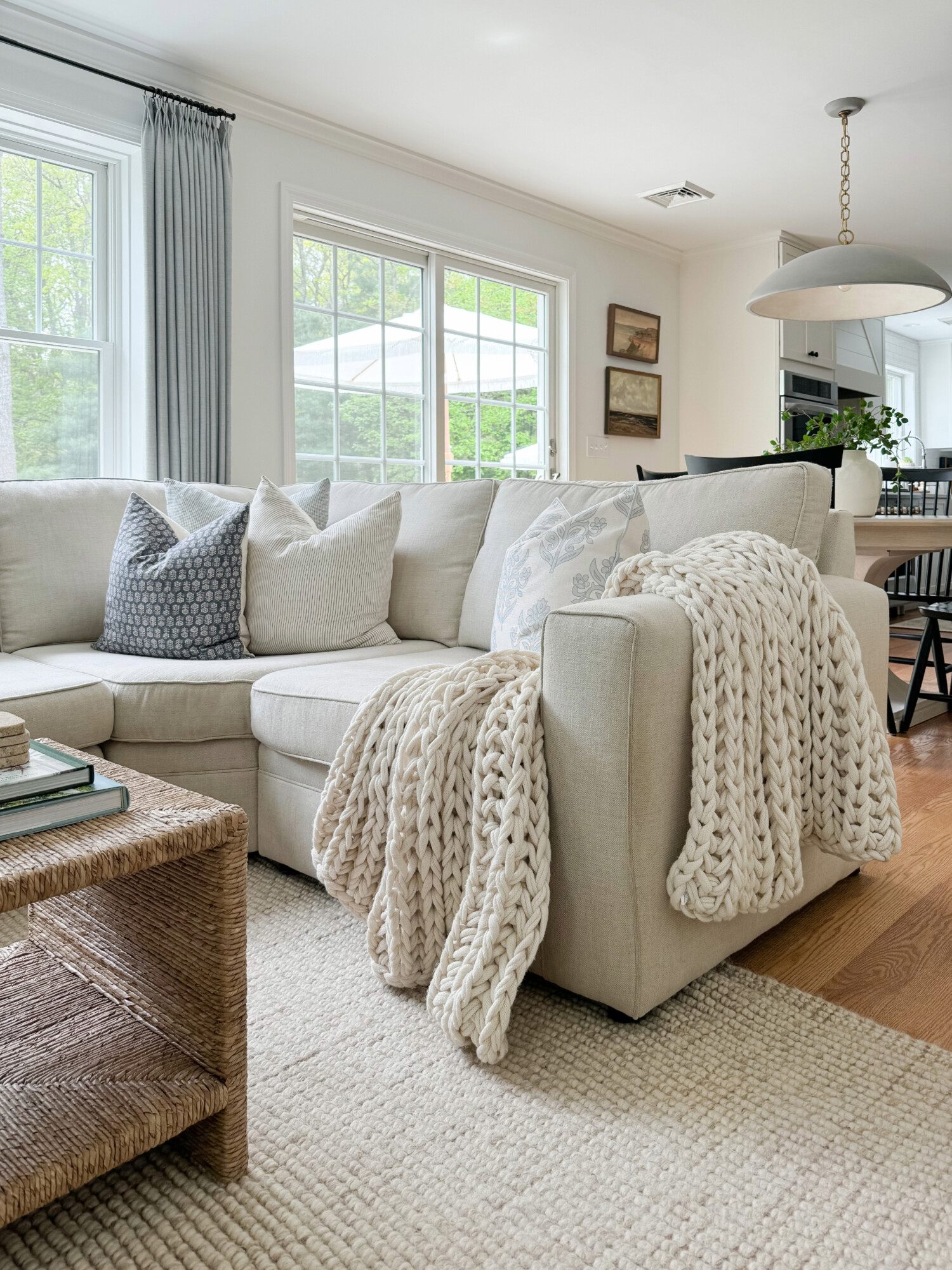 pottery barn beige sectional and knit throw blanket