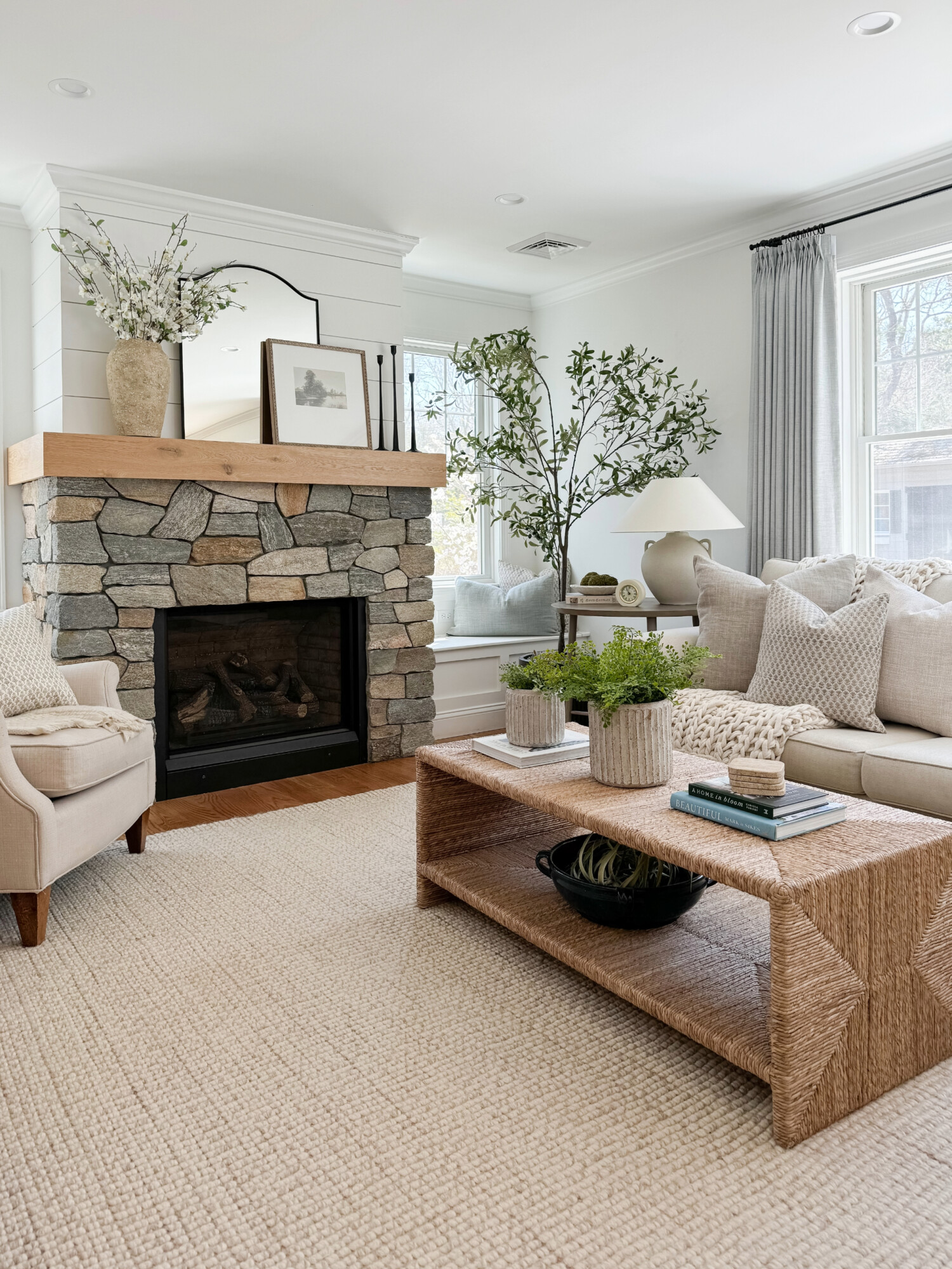 Neutral coastal living room with rock fireplace