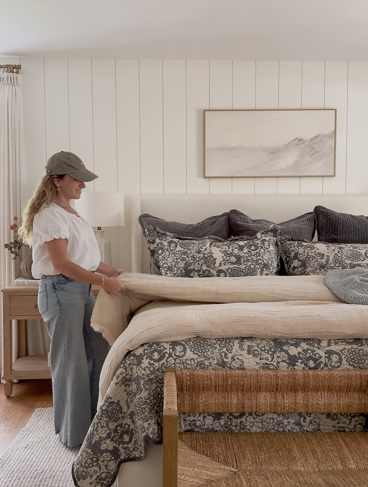 Sherri Calnan Home styling a neutral bedroom with patterned bedding, linen layers, and a woven bench for an inviting fall and winter home refresh.