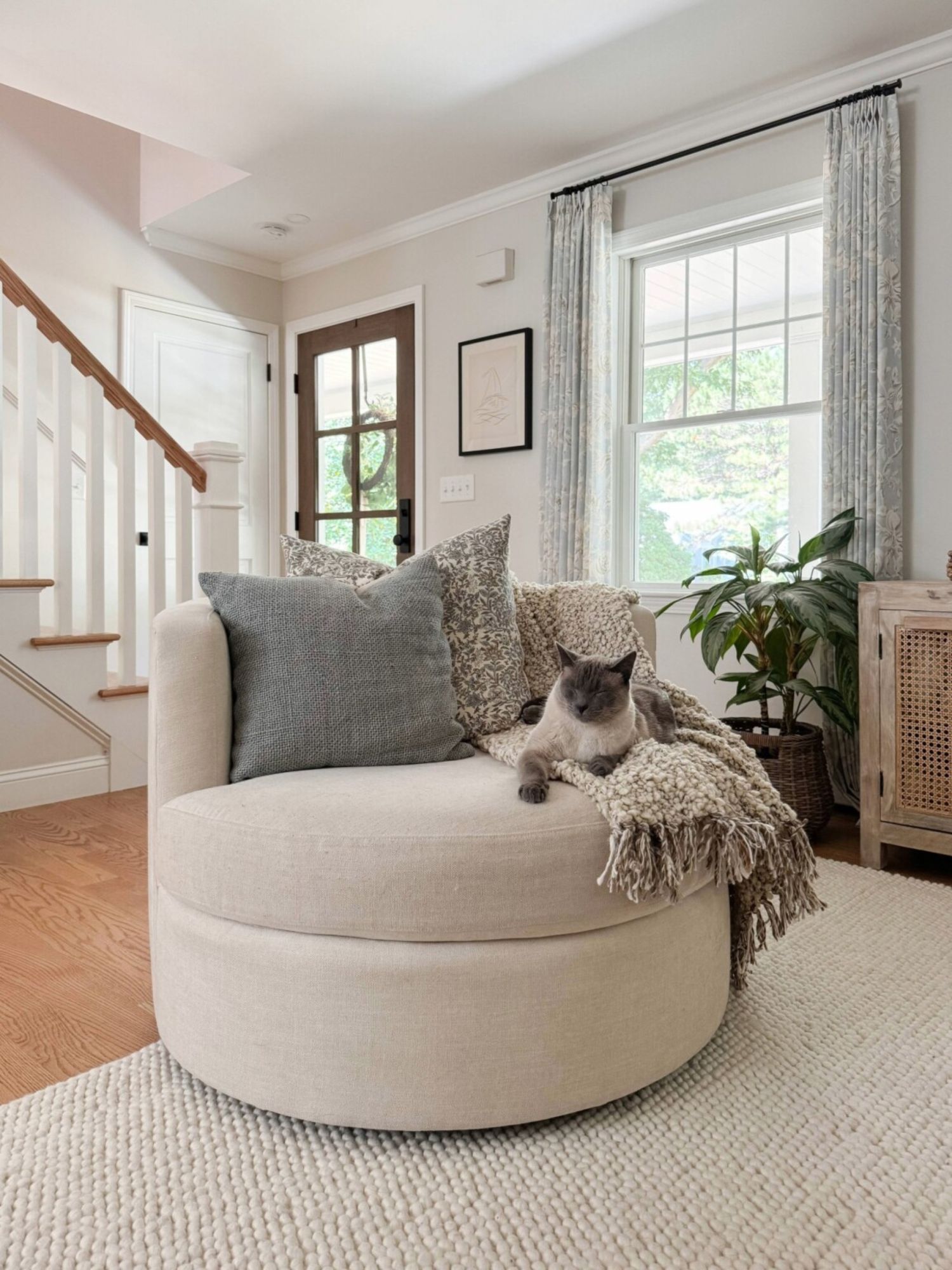 Cozy family room with Balboa swivel chair, neutral rug, and pet friendly seating designed for everyday lounging.