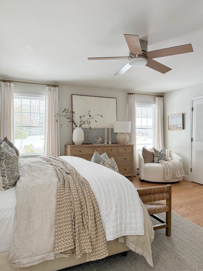 white bedding in a coastal bedding with throw pillows and a throw blanket