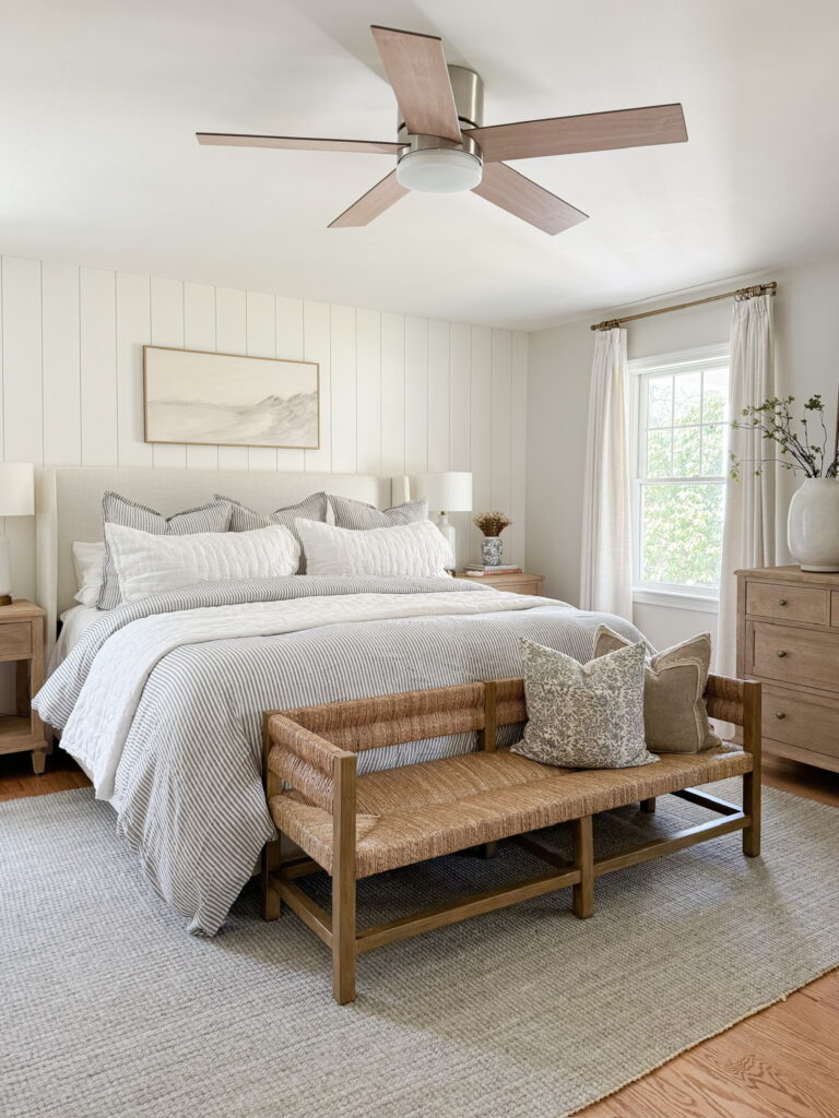 neutral striped bedding and throw pillows