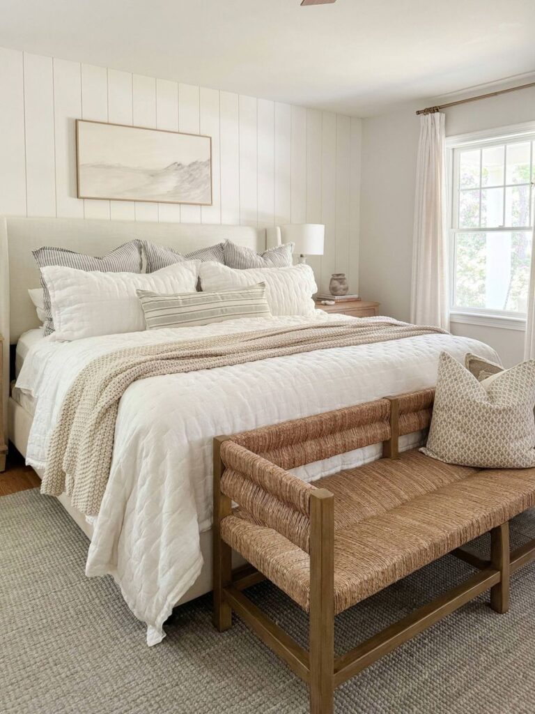 white bedding in a coastal bedding with throw pillows and a throw blanket