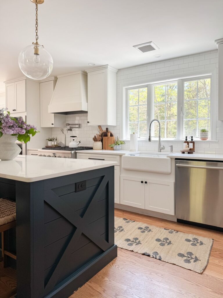 kitchen with runner rug and purple flowers