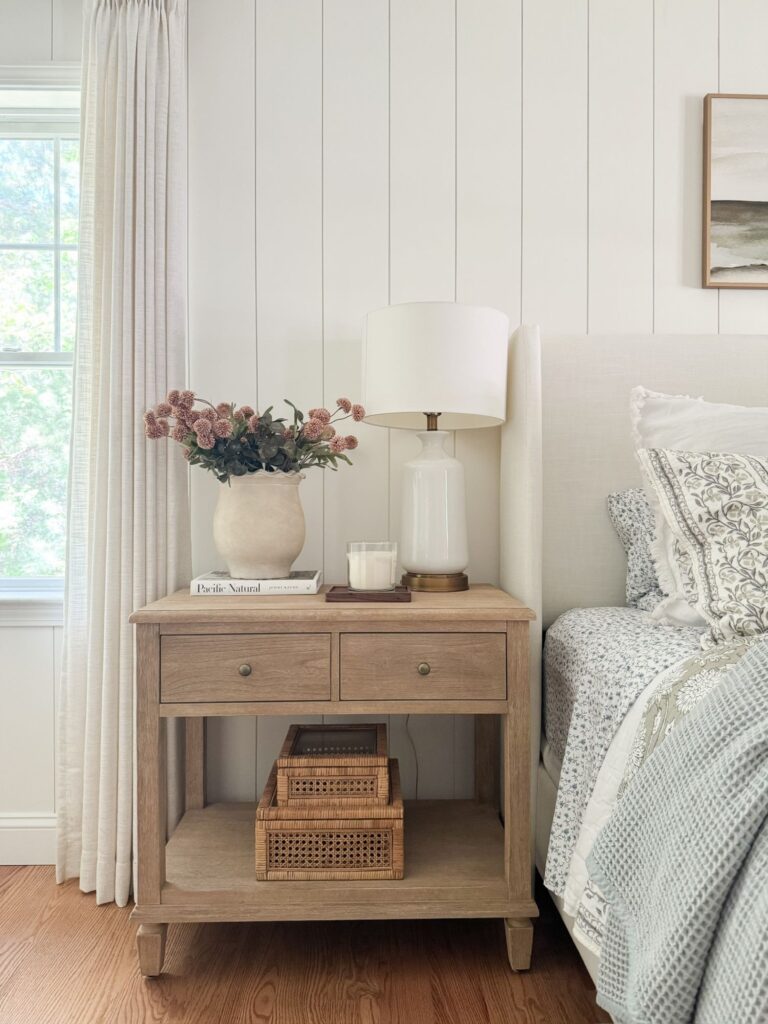 bedside table with lamp and flowers